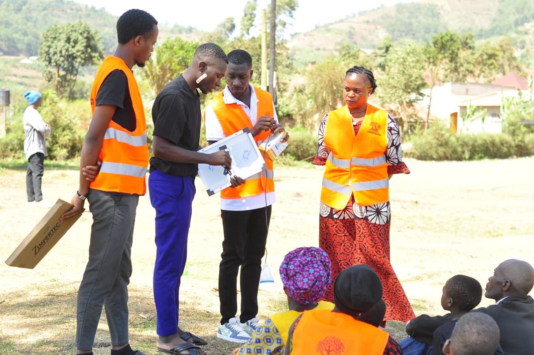 Volunteers reviewing the solar kit box and instructions with families