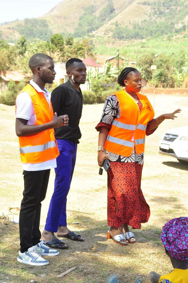 Pathfinders volunteers in orange vests explaining the benefits of solar light